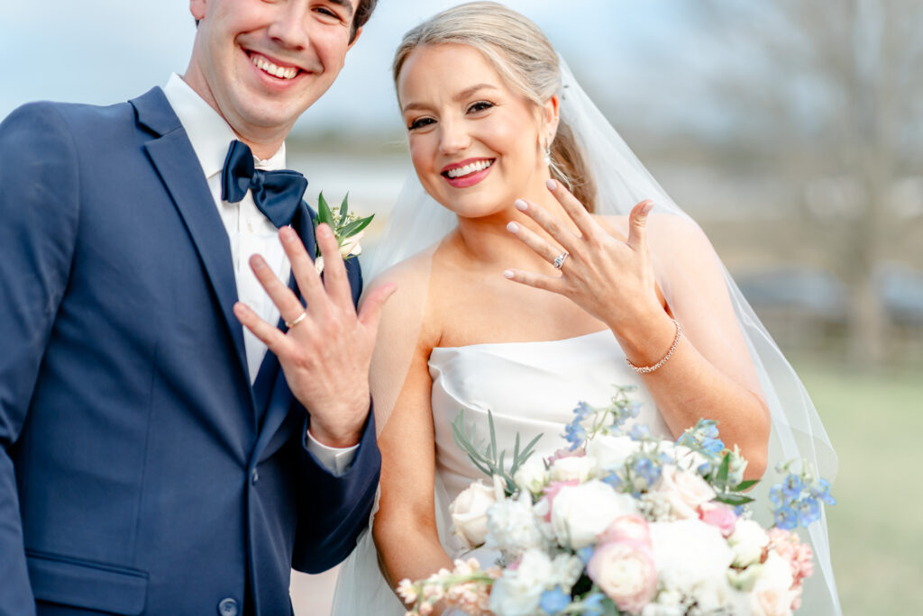 Just Married bride and groom newlyweds showing wedding rings wedding bouquet
